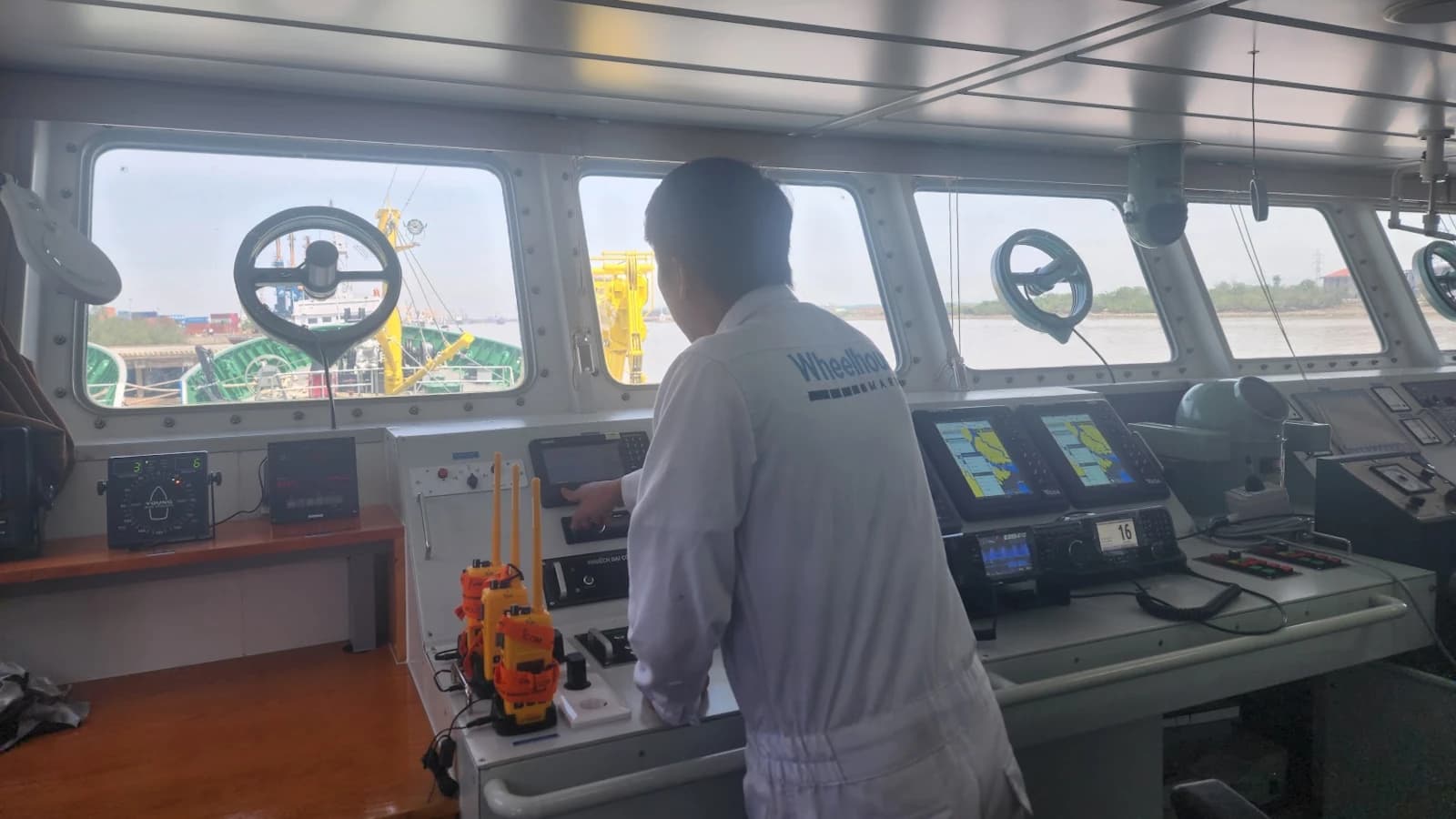 wheelhouse service engineer repairing equipment on bridge