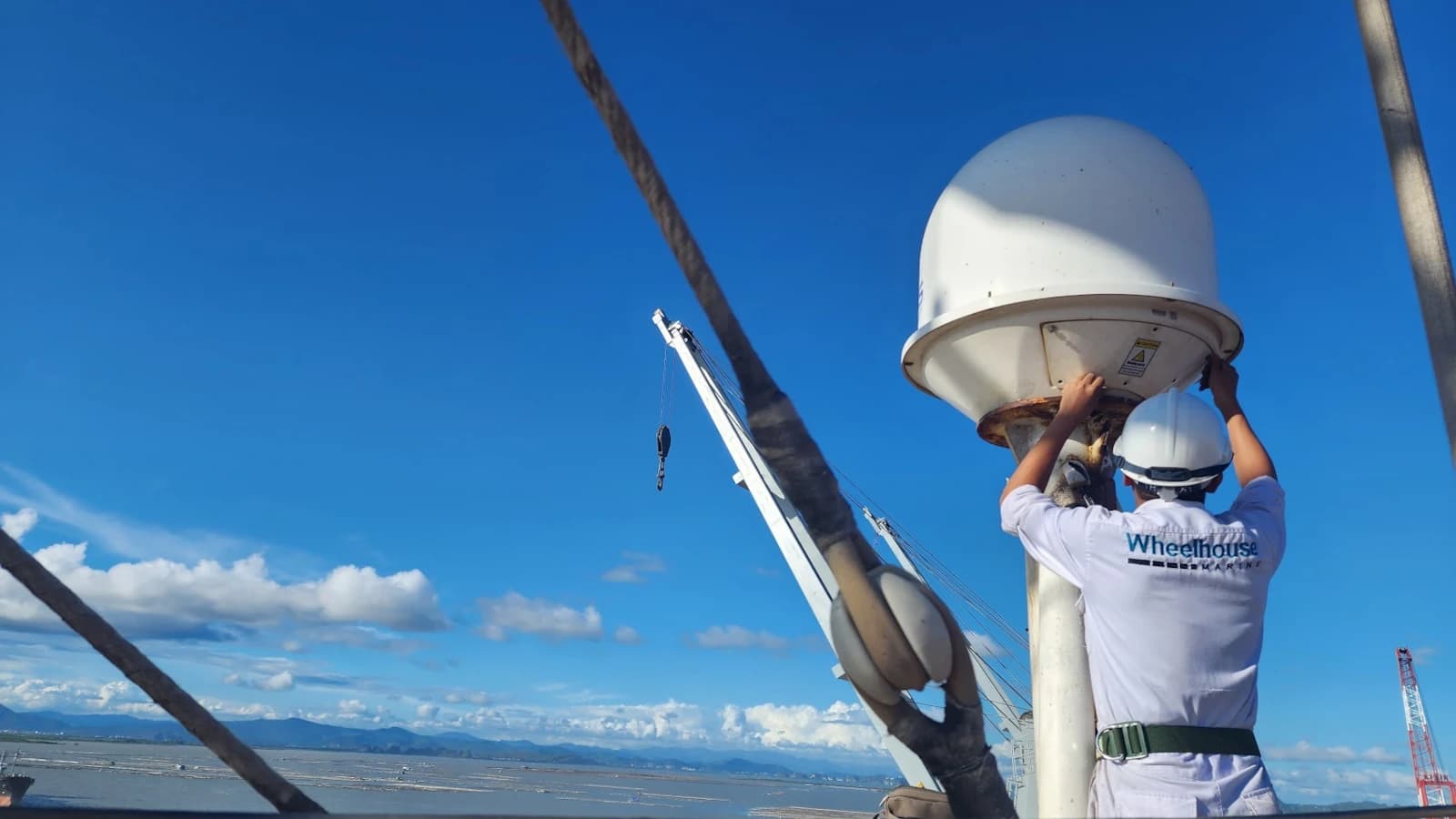 wheelhouse service engineer repairing VSAT antenna on board