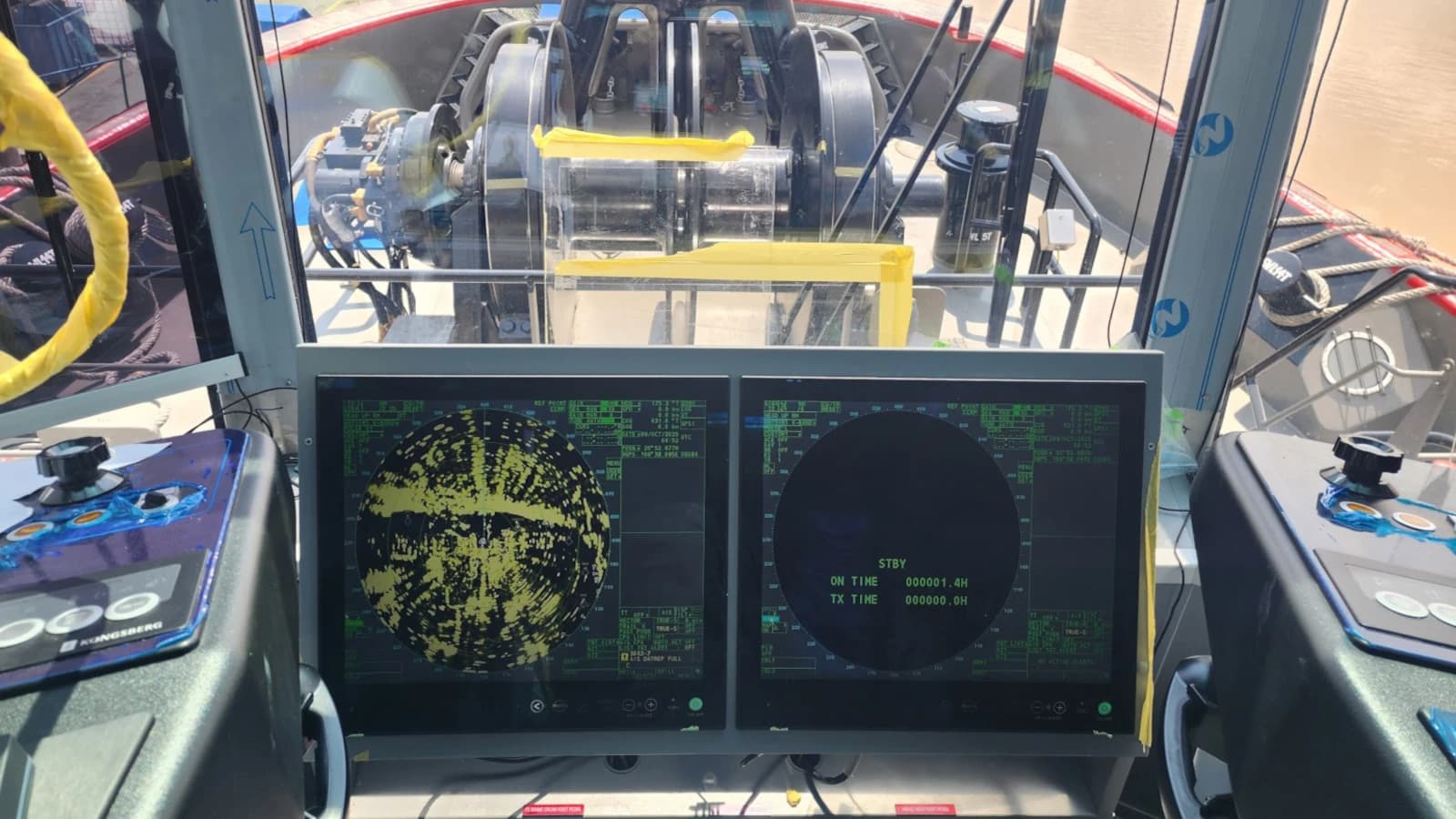 Wheelhouse technician installing equipment on a new building vessel